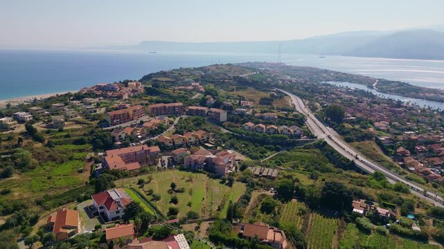 Cinematic aerial drone panorama of Ganzirri and Capo Peloro, Sicily. Stunning coastal landscape near Messina with the Lakes of Ganzirri and the narrow sea channel between Tyrrhenian and Ionian waters