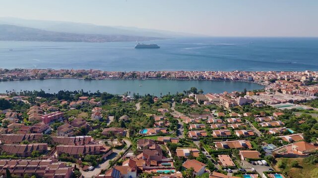 Cinematic aerial drone panorama of Ganzirri and Capo Peloro, Sicily. Stunning coastal landscape near Messina with the Lakes of Ganzirri and the narrow sea channel between Tyrrhenian and Ionian waters