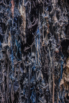 This Japanese clothing store window decoration features shredded recycled denim strips in multiple indigo shades to illustrate ecological practices and the creative reuse of used clothing materials.