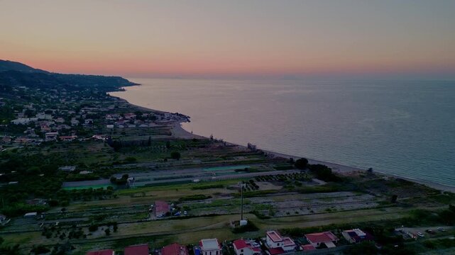 Cinematic aerial drone panorama of Ganzirri and Capo Peloro, Sicily. Stunning coastal landscape near Messina with the Lakes of Ganzirri and the narrow sea channel between Tyrrhenian and Ionian waters