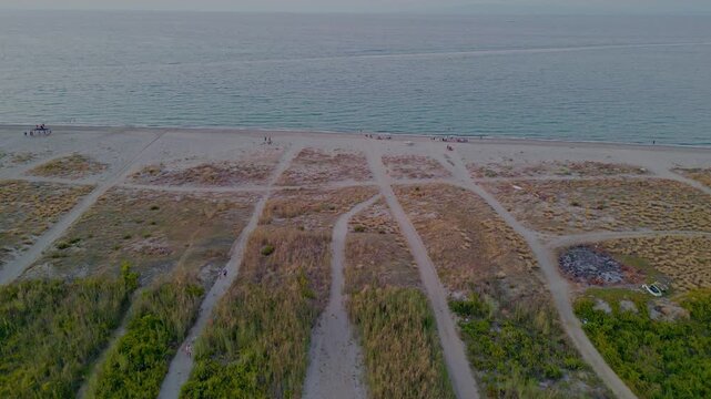 Cinematic aerial drone panorama of Ganzirri and Capo Peloro, Sicily. Stunning coastal landscape near Messina with the Lakes of Ganzirri and the narrow sea channel between Tyrrhenian and Ionian waters