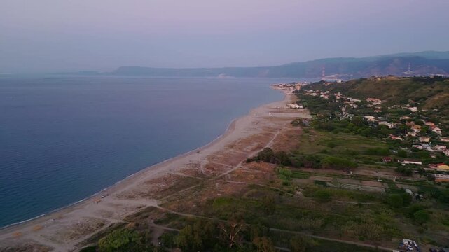 Cinematic aerial drone panorama of Ganzirri and Capo Peloro, Sicily. Stunning coastal landscape near Messina with the Lakes of Ganzirri and the narrow sea channel between Tyrrhenian and Ionian waters