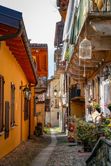 Picturesque narrow alley in an ancient Italian village with traditional architecture and flowers.
