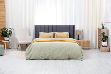 Fototapeta premium Comfortable bed with stylish linens at home. Interior design