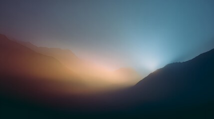 Obraz premium Dramatic Sunset Over Mountain Range with Hazy Sky.