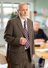 Naklejka premium Upset senior male conference participant or partner is reprimanded. Boss yells at subordinate. Person is upset because of critique from superiors, disapproval from partners, or failed negotiation.