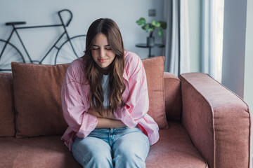 Obraz premium Sick young woman in pain holding belly stomach feeling hurt abdomen ache gastritis pancreatitis symptoms or diarrhea, upset teen girl suffering from indigestion flatulence abdominal problem concept