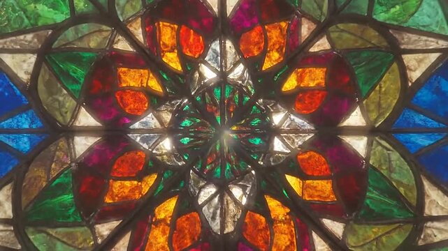 Intricate geometric stained glass window with vibrant colors and patterns