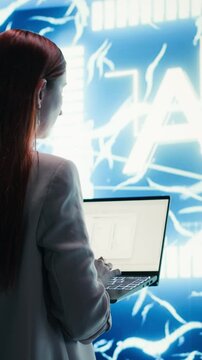 Vertical video Engineer reports to AI brain automated manager displayed on digital dashboard. Woman completes assignments distributed by artificial intelligence agent superintelligence using laptop