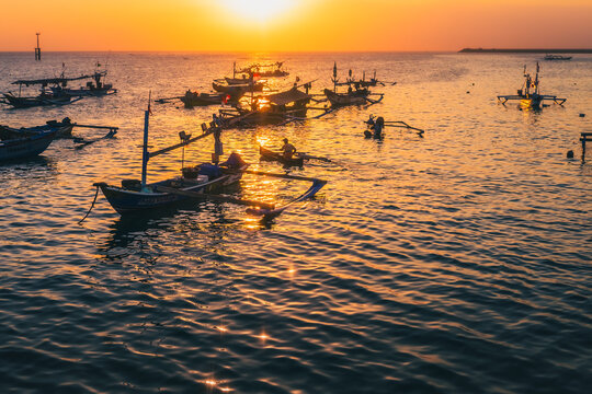 Silhouette of fishing boats parked in the sea near Kedonganan Beach, Jimbaran, Bali, Indonesia
