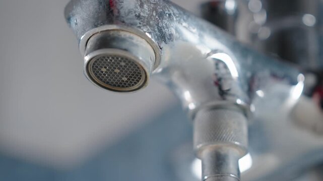 Dripping Water Faucet Close-Up Slow Motion | Old Leaking Bathroom Tap with Limescale and Water Drop | Plumbing Problem and Water Conservation Concept