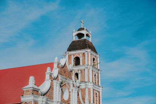 Saint Peter Metropolitan Cathedral Bell Tower with Red Roof and Blue Sky in Tuguegarao City, Cagayan, Philippines