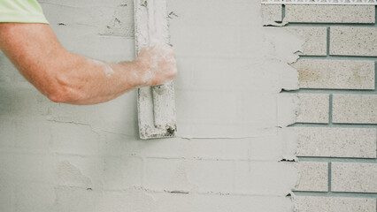 Plastering Rendering Construction Wall Renovation Masonry Handyman applying fresh white plaster...
