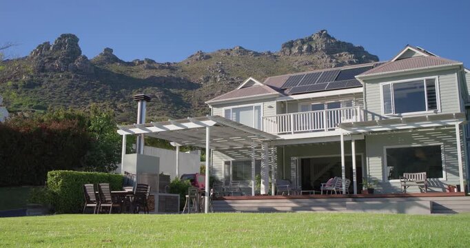 House with pergola and deck is getting sunlight at foothills as sun is moving causing shadows