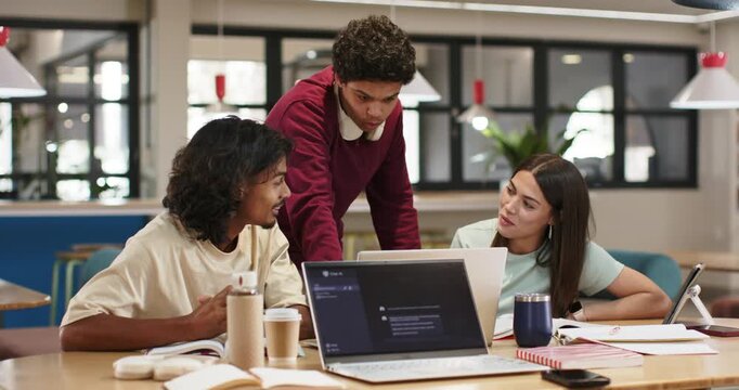 African American team spotting laptop issue standing man leaning pointing and guiding fix at table