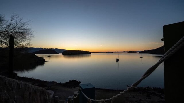 Sunrise over ocean bay with sail boat 