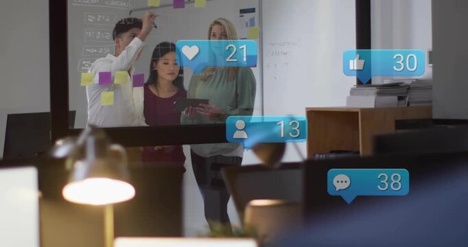 Marketing team of three working behind glass adding notes tapping tablet causing bubbles rising