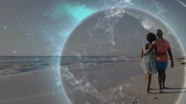 Man and woman walking on beach with prints, globe rising from left, encasing couple, evoking travel