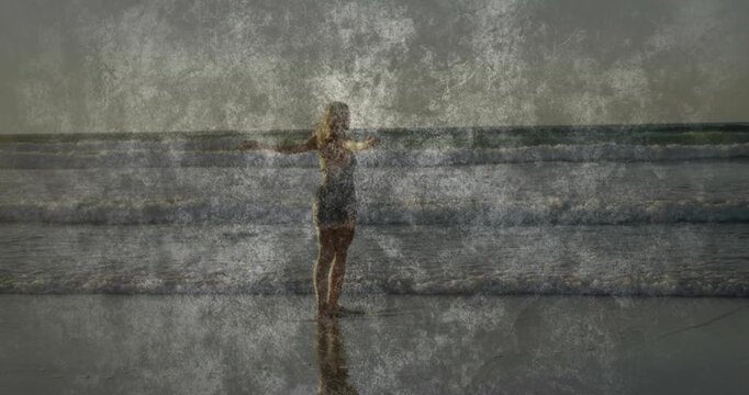 Vertical video: Woman standing arms out, shifting with surf, health overlays animating on figure