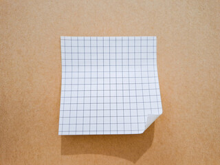 Fototapeta premium white grid sticky note paper on a brown paper background
