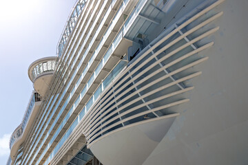 Modern cruise ship navigating ocean on sunny day