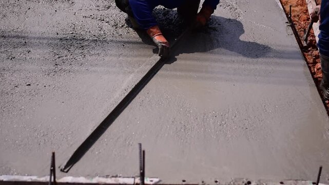 Pouring ready-mixed concrete onto reinforcing bars, We are pouring concrete on reinforced steel for the foundation