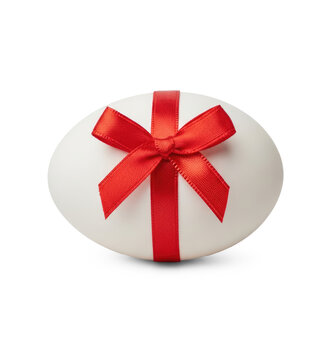A white egg is wrapped with a vibrant red satin ribbon and a large bow. The ribbon is neatly tied, creating a classic gift presentation.