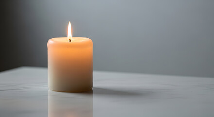 a lit candle sitting on a table with a white background