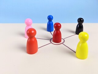 Obraz premium team leader concept. A circle of people surrounds a red person. This depiction represents the essence of business teamwork, showcasing the power of collaboration, team spirit and collective effort.
