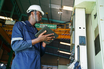 Professional quality control engineer inspecting precision automotive metal parts in a...