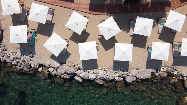 Travelling Top View over Emerald Beach Umbrellas, Angsana Hotel, Corfu, Greece