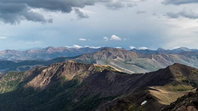 Clouds and sunlight moving over layered mountain ridges and valleys, Absaroka Range, Montana, time lapse