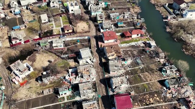 Aerial view of a town with damaged houses and destroyed infrastructure during Iran Israel War. 