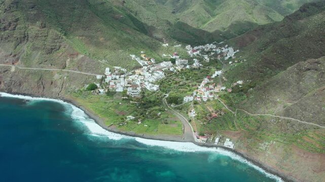 Beautiful aerial perspective of the secluded village of Igueste de San Andres, nestled in a lush green valley on the coast of Tenerife