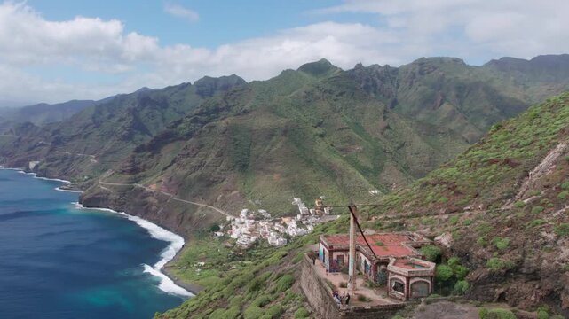 Aerial drone view flying over an abandoned building Semaforo, revealing the coastal village of Igueste de San Andres in Tenerife, Canary Islands