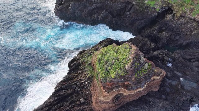 Striking aerial view of the Roque de El Cagado, a unique volcanic rock formation along the rugged coastline of Santa Ursula, Tenerife