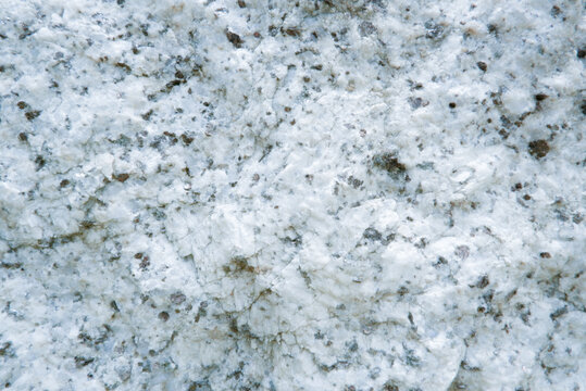Close up of granite surface texture. Intrusive igneous rock