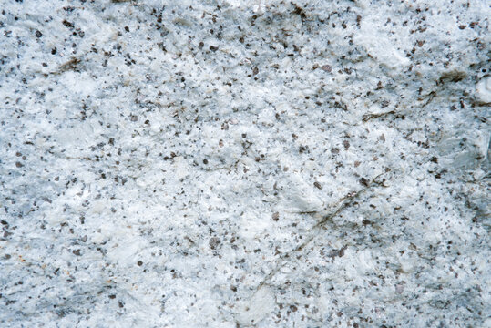 Close up of granite surface texture. Intrusive igneous rock