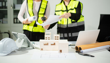 Engineer teams meeting working together wear worker helmets hardhat on construction site in modern...