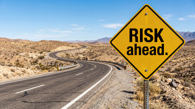 Risk Ahead Warning Road Sign on Desert Highway Curve