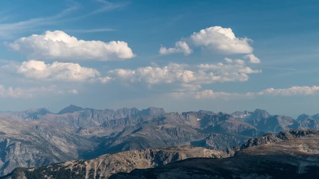 Cumulus clouds drifting over a vast panorama of rugged peaks in the Beartooth highlands, Montana, time lapse