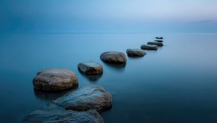 Stones emerge from calm water creating a serene path