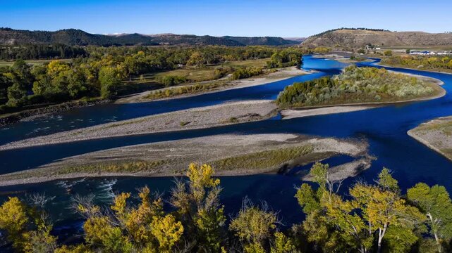 Aerial hyperlapse over the braided Yellowstone River with gravel bars, islands and fall cottonwoods, Montana