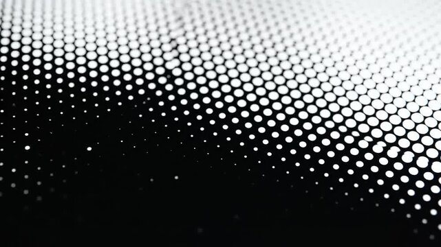 Close up of a black and white dotted pattern creating a visually dynamic effect