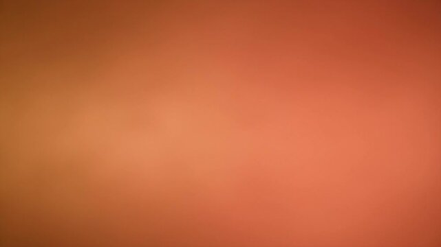 Blurred and faded orange and peach gradient background with soft texture