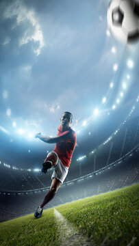 Football player is kicking a ball in the stadium. An imaginary stadium is modelled and rendered.