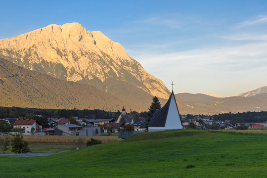 Peace Chapel in Obsteig Tyrol Alps with mountains at sunset