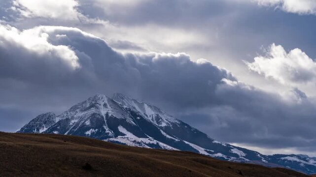 Storm clouds and snow squalls passing over and hiding Emigrant Peak, then clearing, Paradise Valley, Montana, time lapse