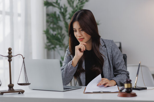 Female lawyer working on legal matters using laptop