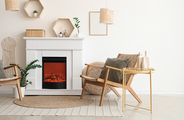 Naklejka premium Interior of light living room with fireplace and wicker armchair near white wall